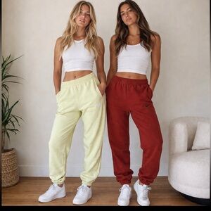 Nike T W O PAIRS Fleece Joggers in Green/Yellow and Brick Red - New